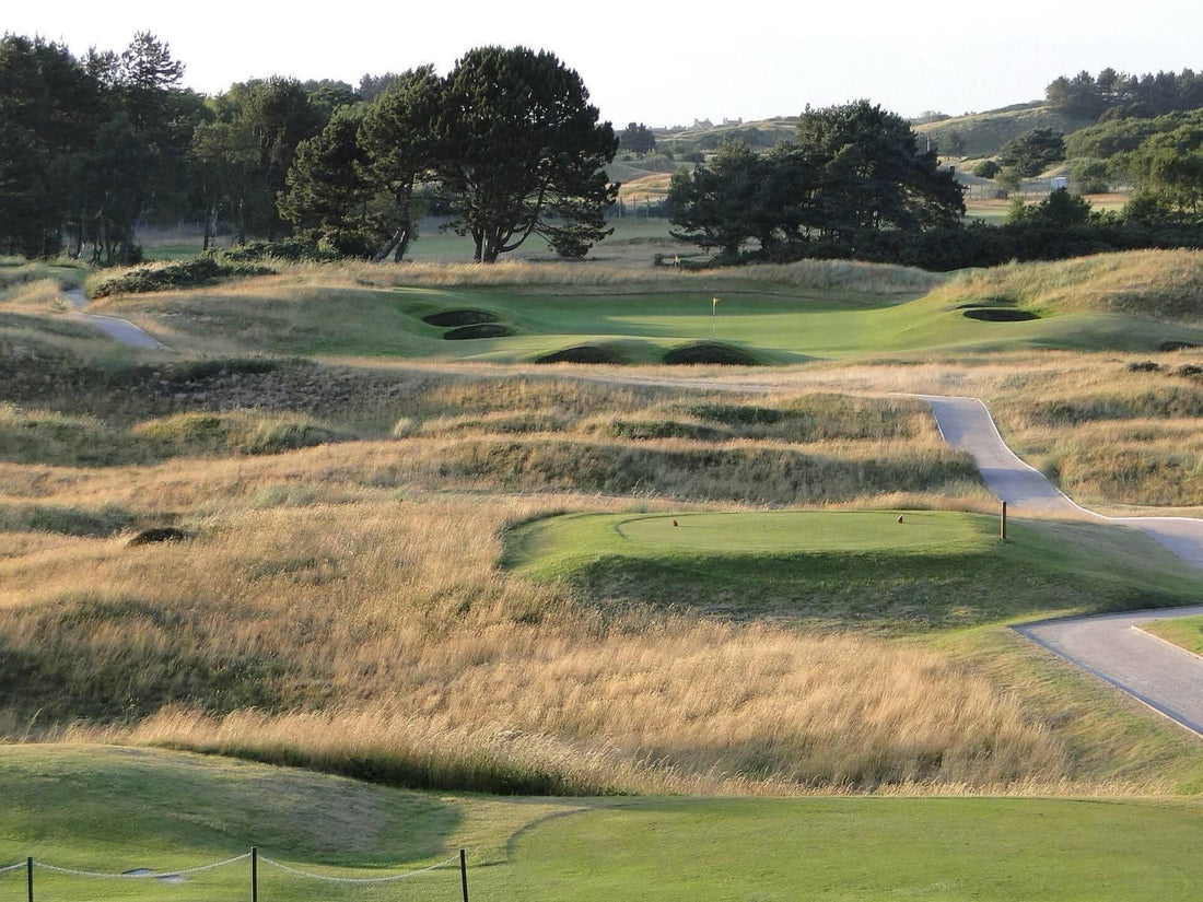 Evening sunlight over the dune lined 1st hole at Southport and Ainsdale Golf Club, with golden rough, pot bunkers and a raised green among the sandhills